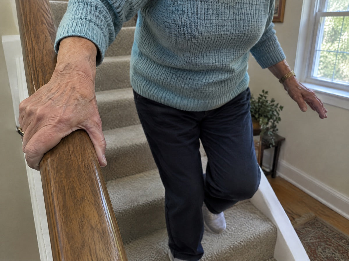 A hand gripping the stair rail